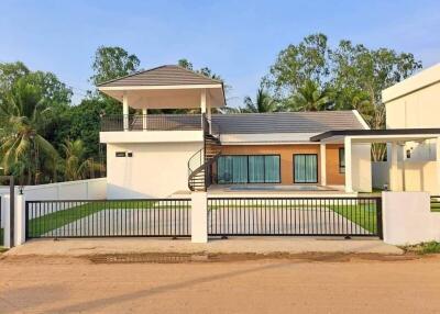 Modern two-story house with a spacious yard and outdoor patio