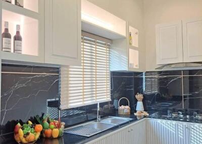 Modern kitchen with white cabinets and black countertops