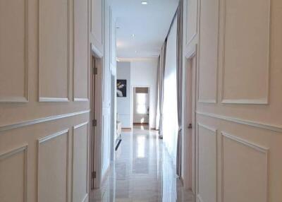 Spacious hallway with wainscoting and marble flooring