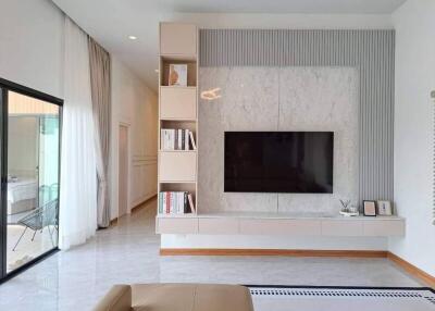 Modern living room with built-in shelving and TV