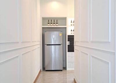 narrow kitchen with refrigerator