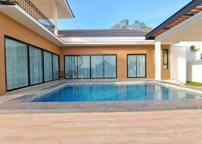 Modern outdoor pool area with surrounding patio in a contemporary house