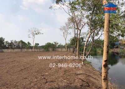 Land plot with water body and trees