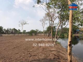 Land plot with water body and trees