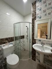 Modern bathroom with shower and decorative tiles