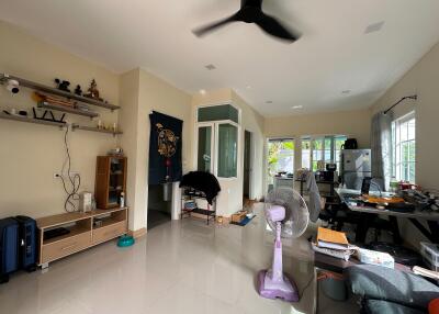 Spacious living room with natural light and tile flooring