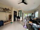 Spacious living room with natural light and tile flooring