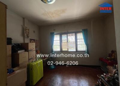 Bedroom with large window and boxes