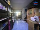 A modest kitchen with storage cabinets, appliances, and a tiled floor