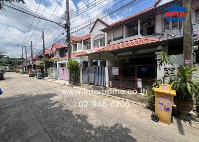 Street view of residential houses with red-tiled roofs