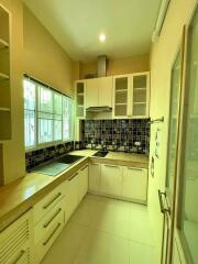 Modern kitchen with white cabinets and tiled backsplash