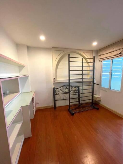 Bedroom with shelves and wooden floor