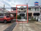 Front view of residential townhouse with attached garage and driveway