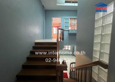 Interior hallway with stairway and blue walls