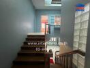 Interior hallway with stairway and blue walls