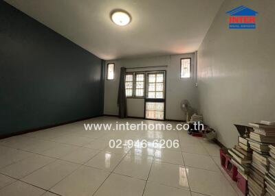 Spacious living room with tiled flooring and large window