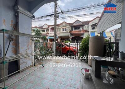 View of an outdoor patio area with houses in the background