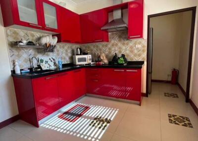 Modern kitchen with red cabinets and appliances