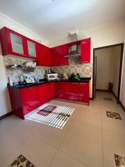 Modern kitchen with red cabinets and appliances