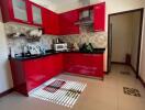 Modern kitchen with red cabinets and appliances