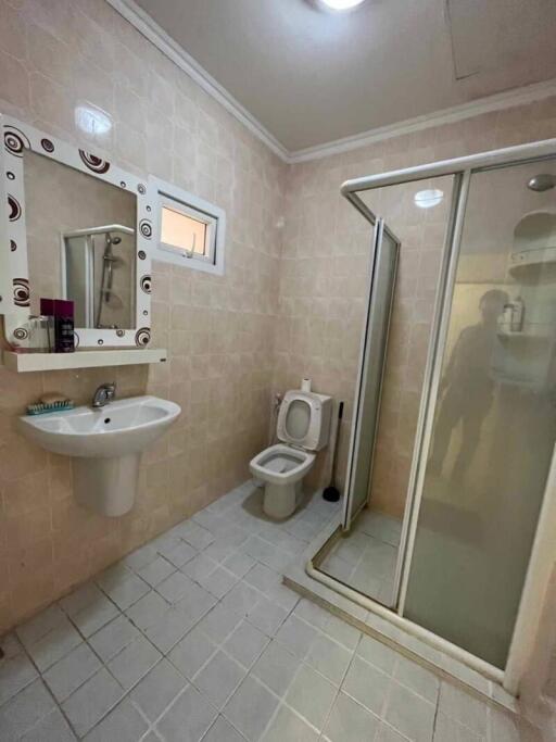 Bathroom with sink, toilet, and shower