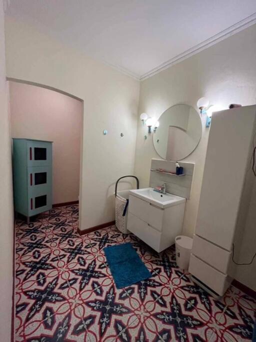 Well-lit bathroom with a mirror and vanity