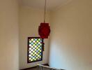 Staircase with colorful window and hanging lamp