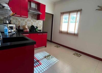 Bright kitchen with red cabinets and modern appliances