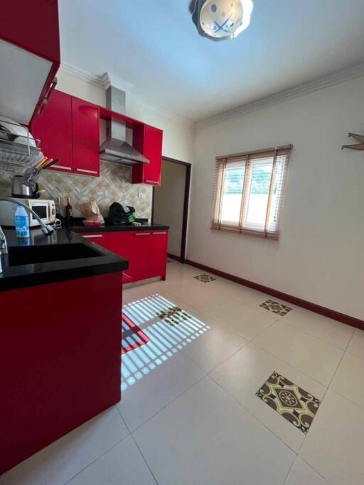 Bright kitchen with red cabinets and modern appliances