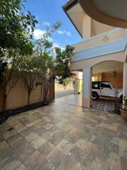 Outdoor space with tiled flooring and covered parking area