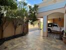 Outdoor space with tiled flooring and covered parking area