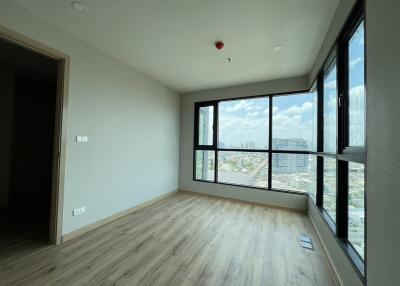 Spacious living room with large windows and a view of the city