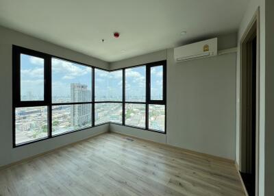 Spacious living room with large windows and city view