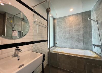 Modern bathroom with glass shower and tiled walls