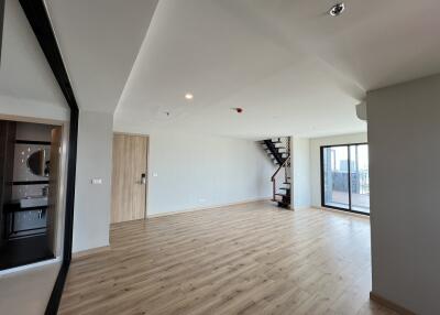 Modern living room with staircase and wooden flooring