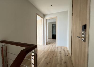 Modern hallway with wooden floors and multiple doors