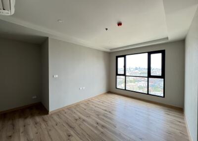 Spacious living room with large windows and city view