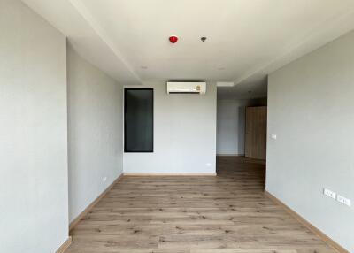 Spacious living room with wooden flooring and air conditioning