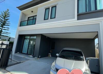 Front view of a modern two-story house with a driveway