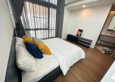 Modern bedroom with large window and mezzanine