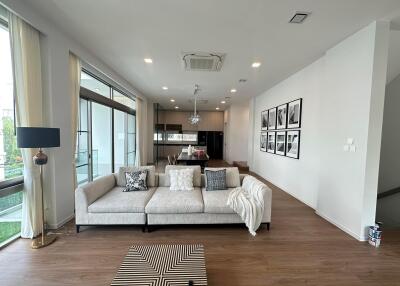 Modern living room with large windows and contemporary furnishings