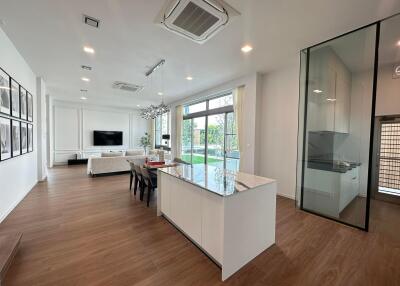 Spacious open-plan living and dining area with modern kitchen