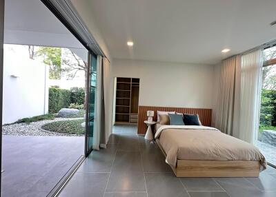 Spacious bedroom with large sliding glass doors and walk-in closet