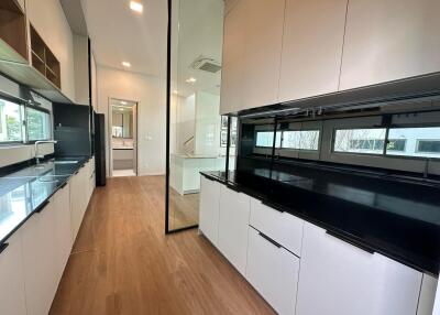 Modern kitchen with black countertops and white cabinetry