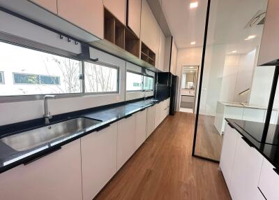 Modern kitchen with black countertops and white cabinets