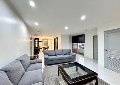 Modern living room with grey couches and glass coffee table