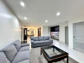 Modern living room with grey couches and glass coffee table