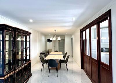 Elegant dining area with table setup and glass cabinet