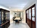 Elegant dining area with table setup and glass cabinet