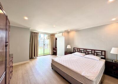 Spacious bedroom with large window and balcony access